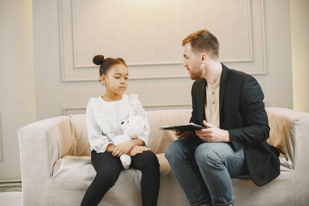 Man in Black Blazer Talking to a Child