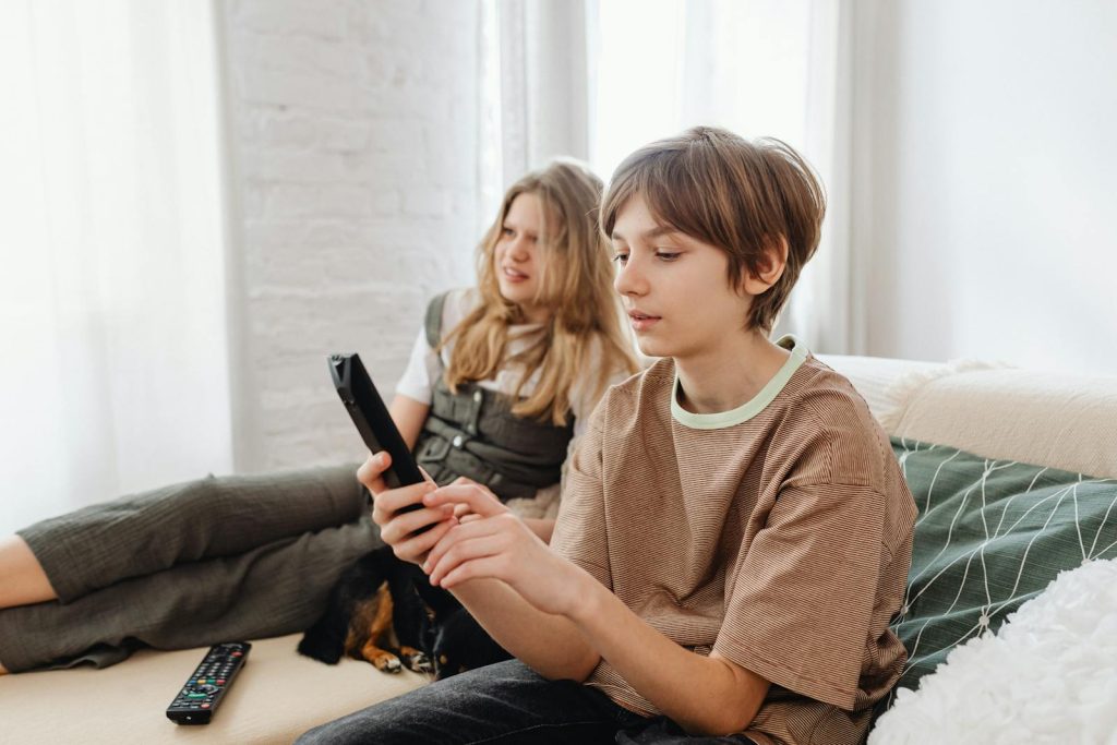 A Boy Holding a TV Remote