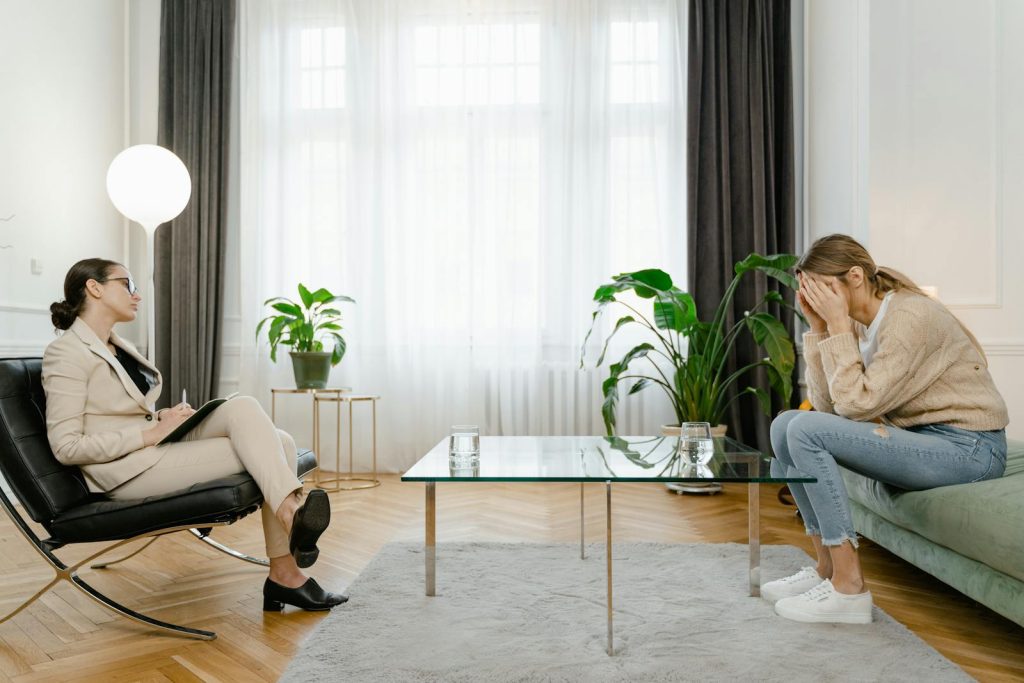 Two Women Talking while Sitting on the Sofa